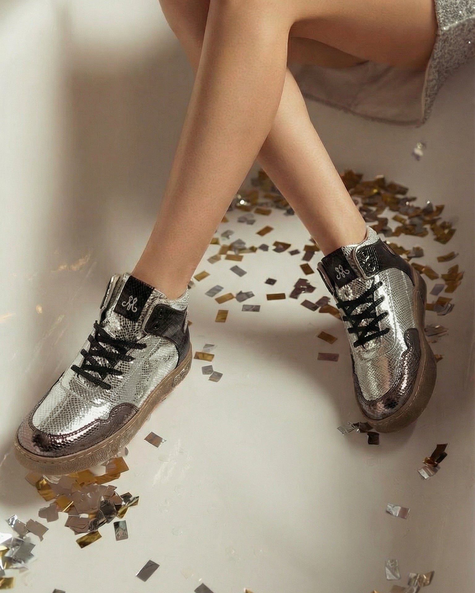 Silver Vortex high-top metallic snake texture sneakers worn with silver sequin dress at party — Solemates by Palak