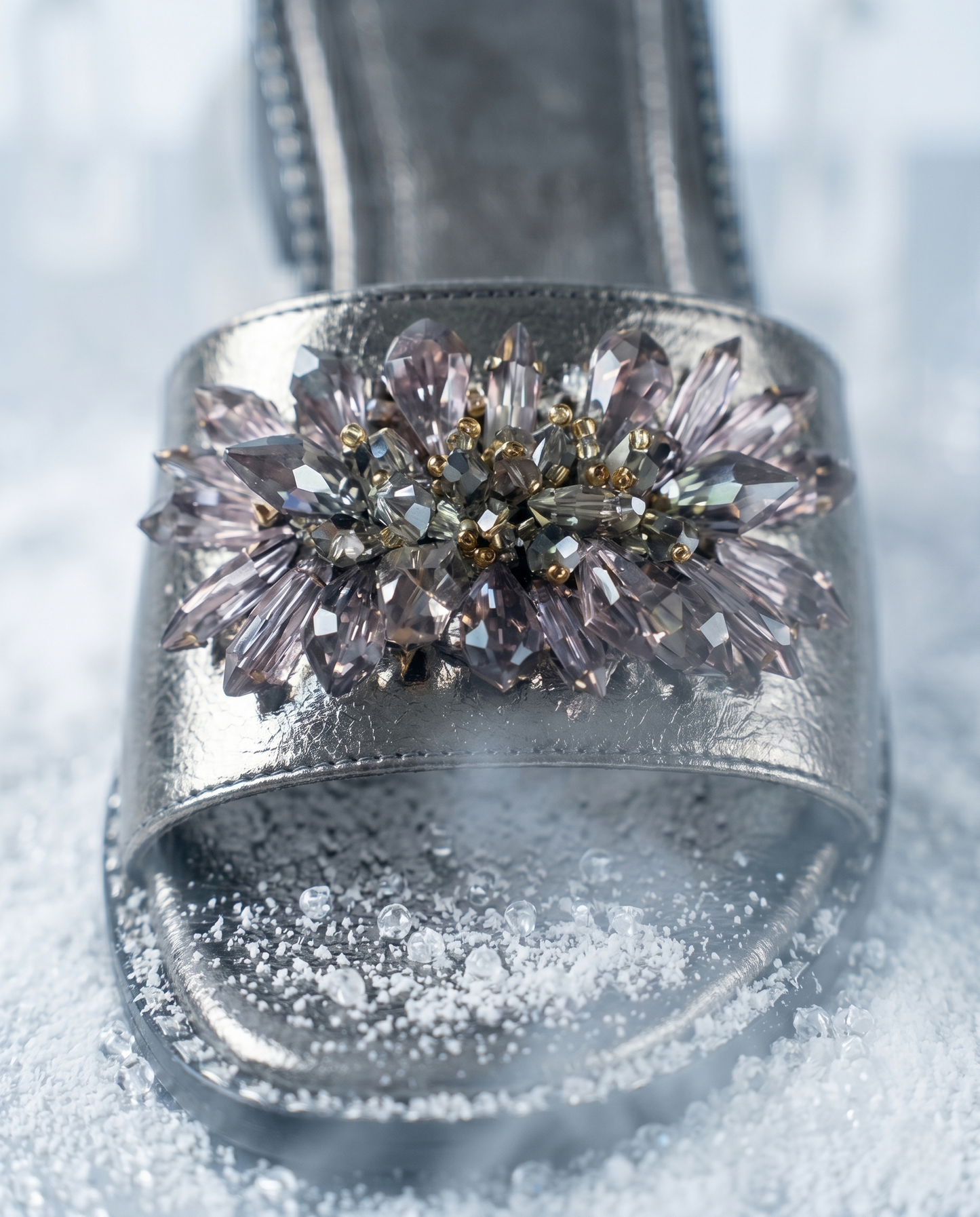 Grey Mirage Flat Sliders crystal brooch close-up — smoky grey faceted crystals, baguette stones and gold seed bead centre on gunmetal metallic strap by Solemates by Palak
