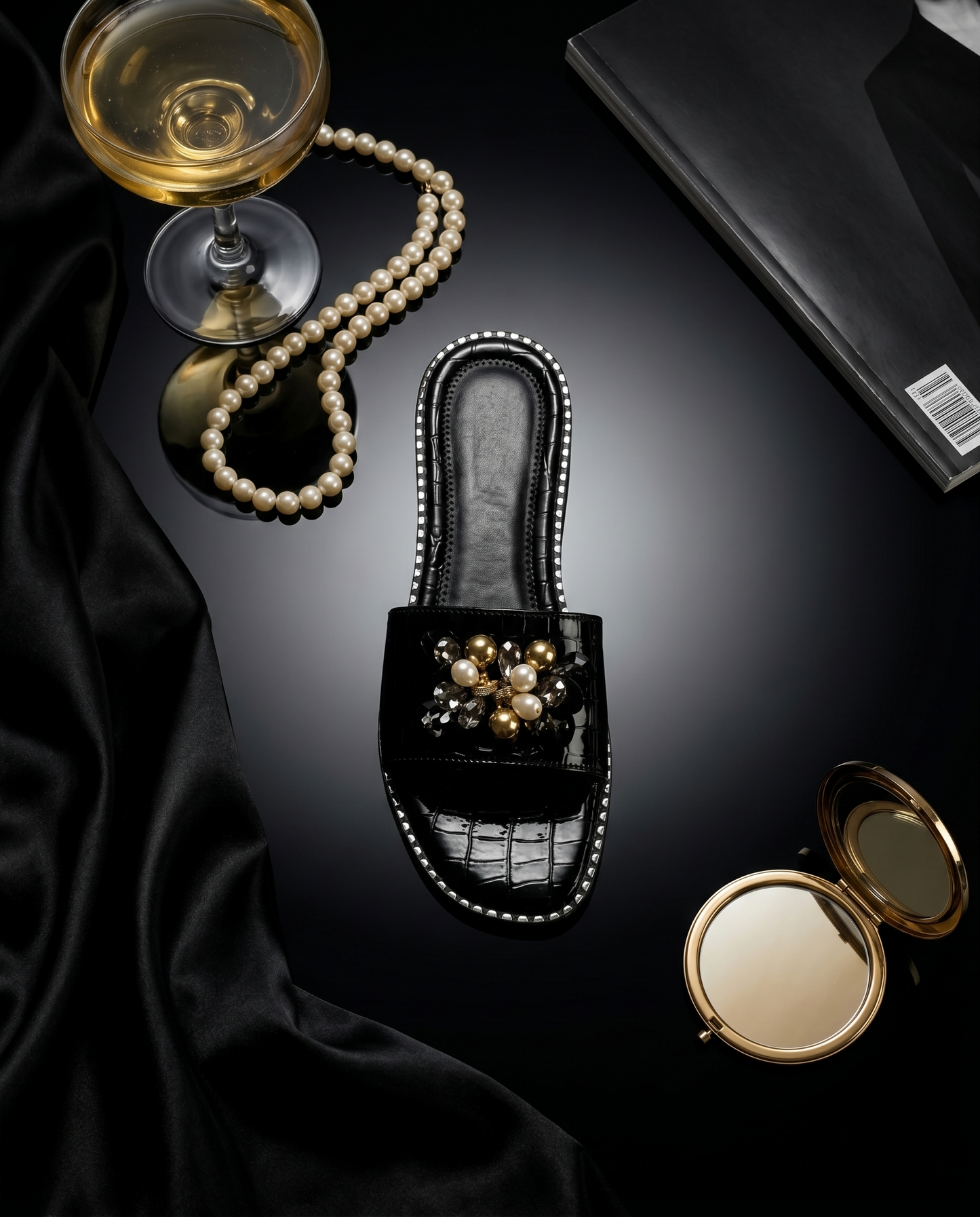 Topaz Black Flat Sliders top view with pearl necklace and champagne coupe — black patent croc flat sliders with gold bead and pearl floral brooch by Solemates by Palak