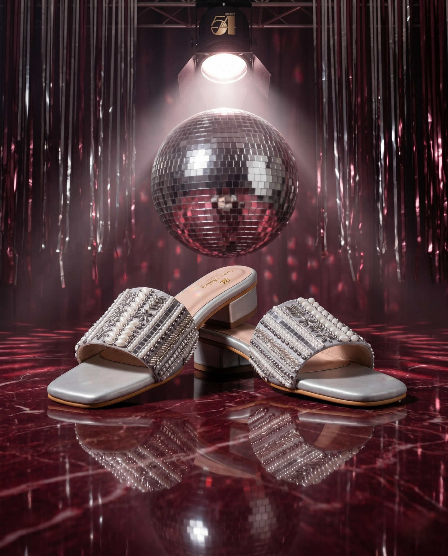 Kate Silver Sliders in front of large disco ball under spotlight — silver multi-bead embellished low block heel sliders by Solemates by Palak