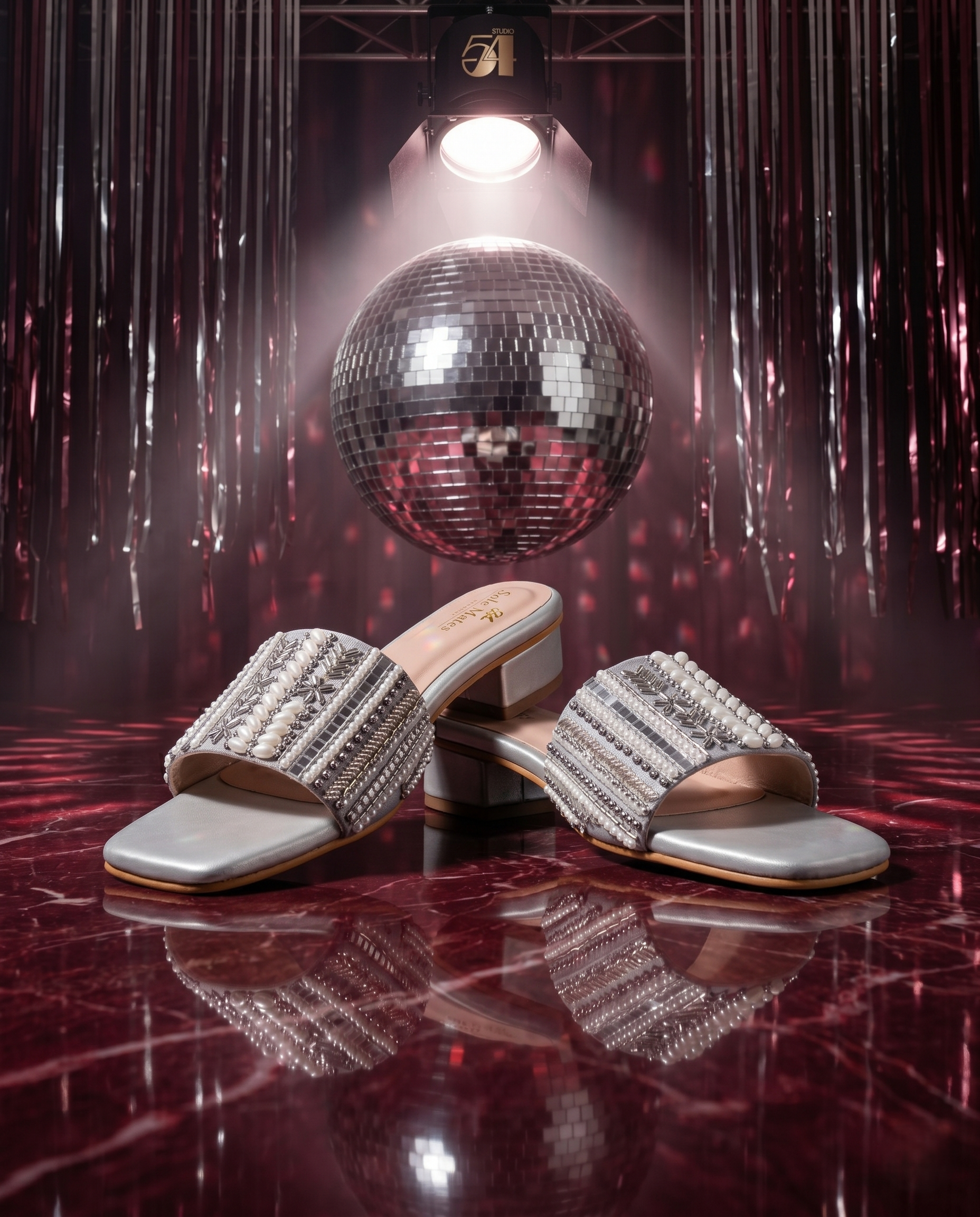 Kate Silver Sliders in front of large disco ball under spotlight — silver multi-bead embellished low block heel sliders by Solemates by Palak