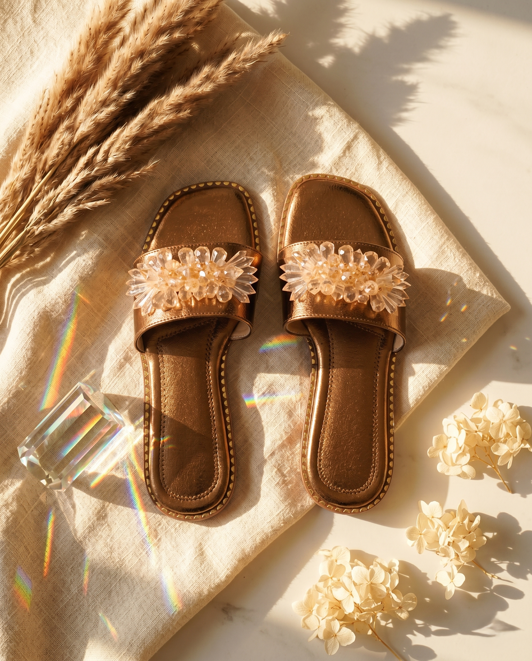Copper Mirage slider pair top-down flat lay — copper metallic pebbled upper with 3D crystal floral embellishment and gold stud sole trim by Solemates by Palak